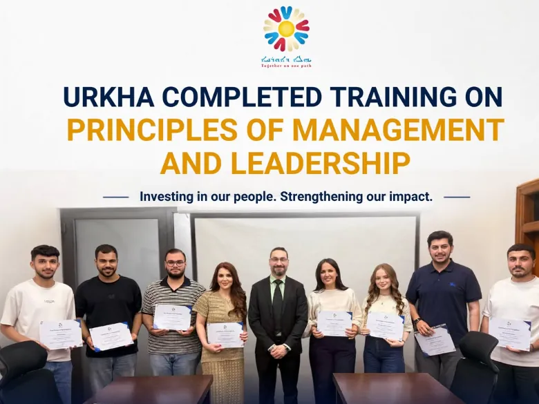 Nine people standing in a row holding their certificates on the last day of Urkha&rsquo;s two-week course in principles of management and leadership.